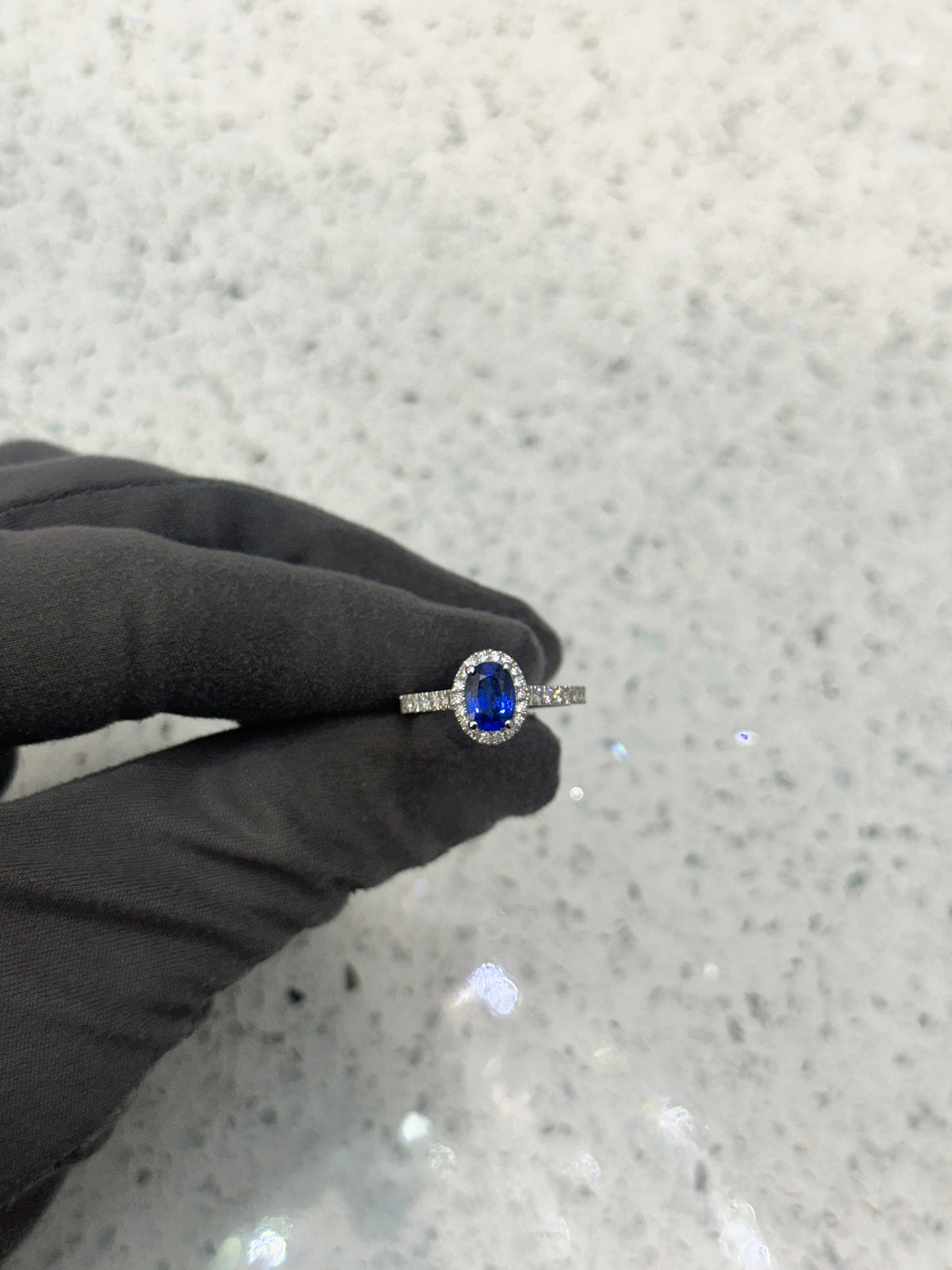 Platinum Blue Sapphire & Diamond Halo Oval Ring with diamond set shoulders