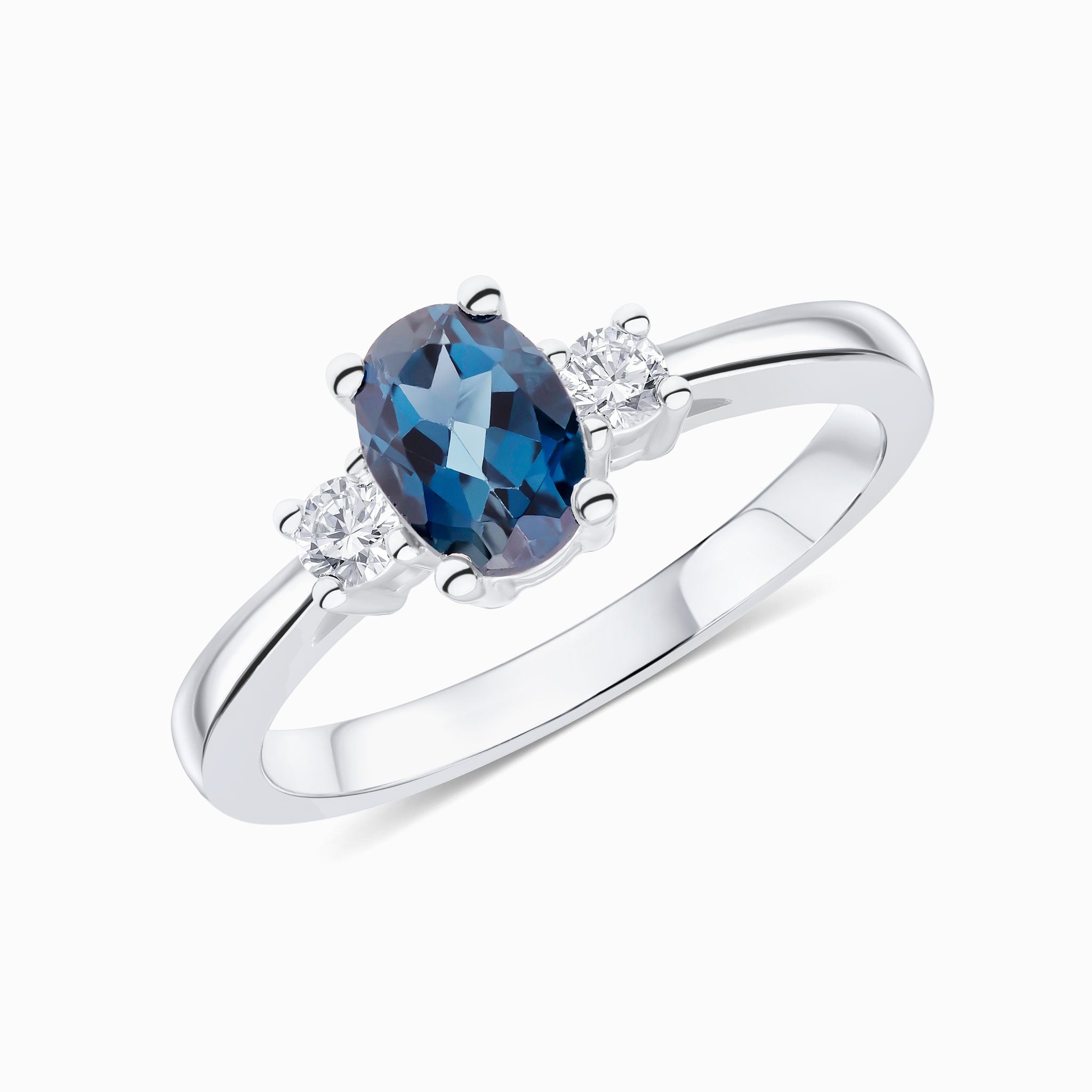 9CT WG 7X5 OVAL LONDON BLUE TOPAZ AND ROUND DIAMOND CLAW SET 3ST RING