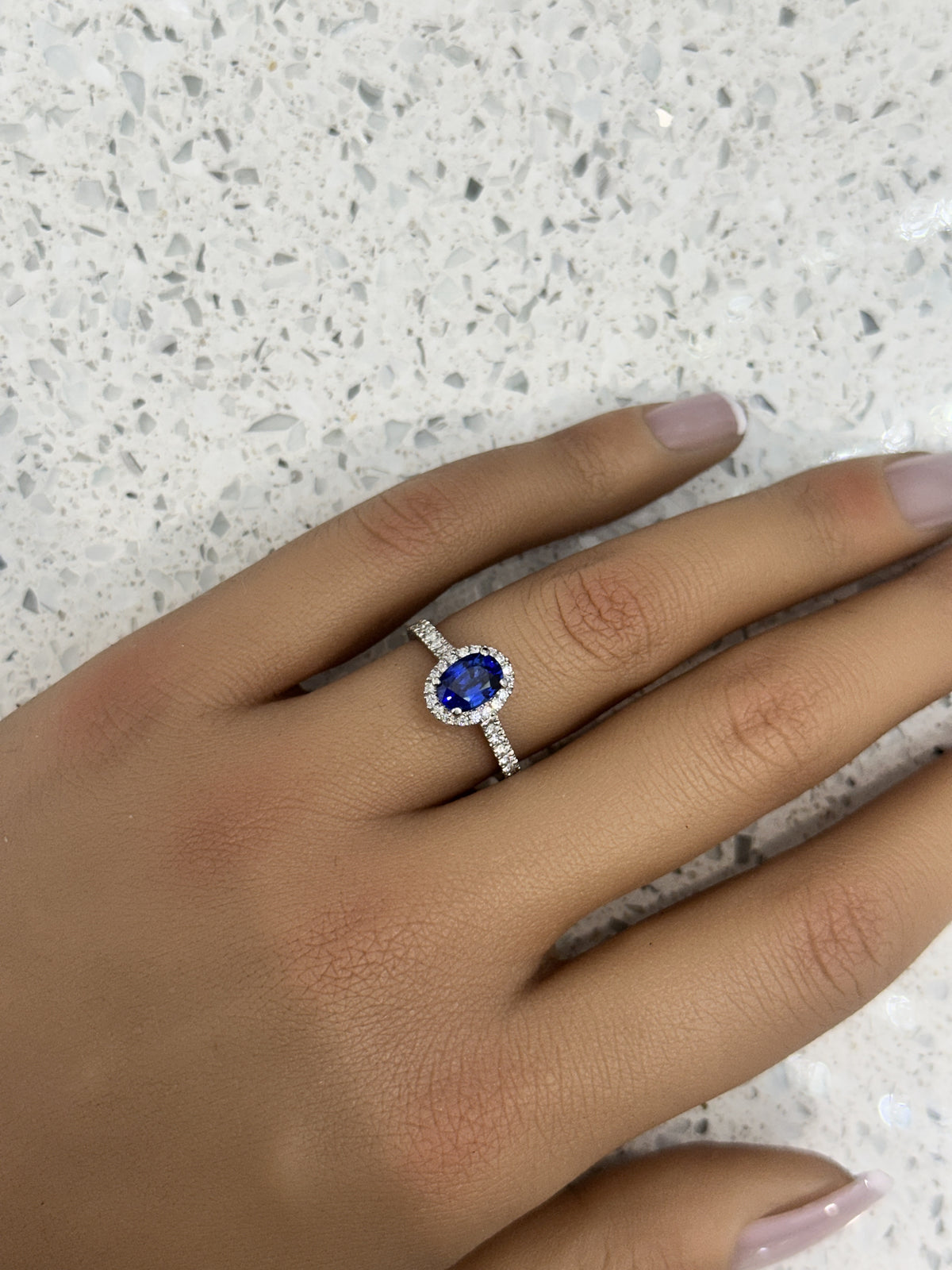 Platinum Blue Sapphire & Diamond Halo Oval Ring with diamond set shoulders